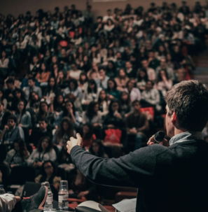 man speaking in front of crowd